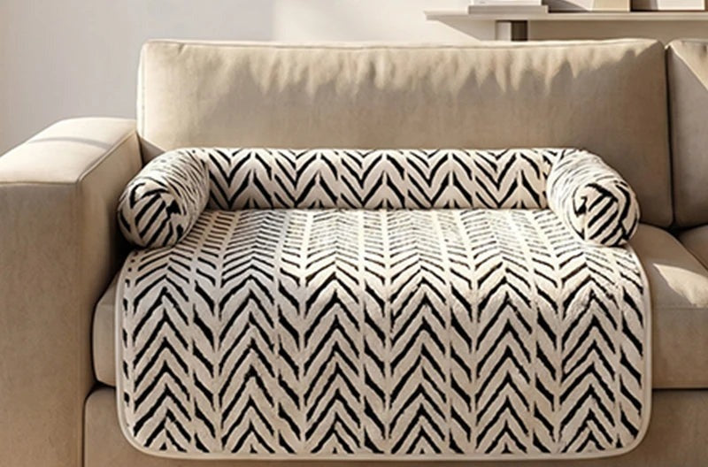 White herringbone Cozy Sofa Mat with bolsters laid on a beige sofa